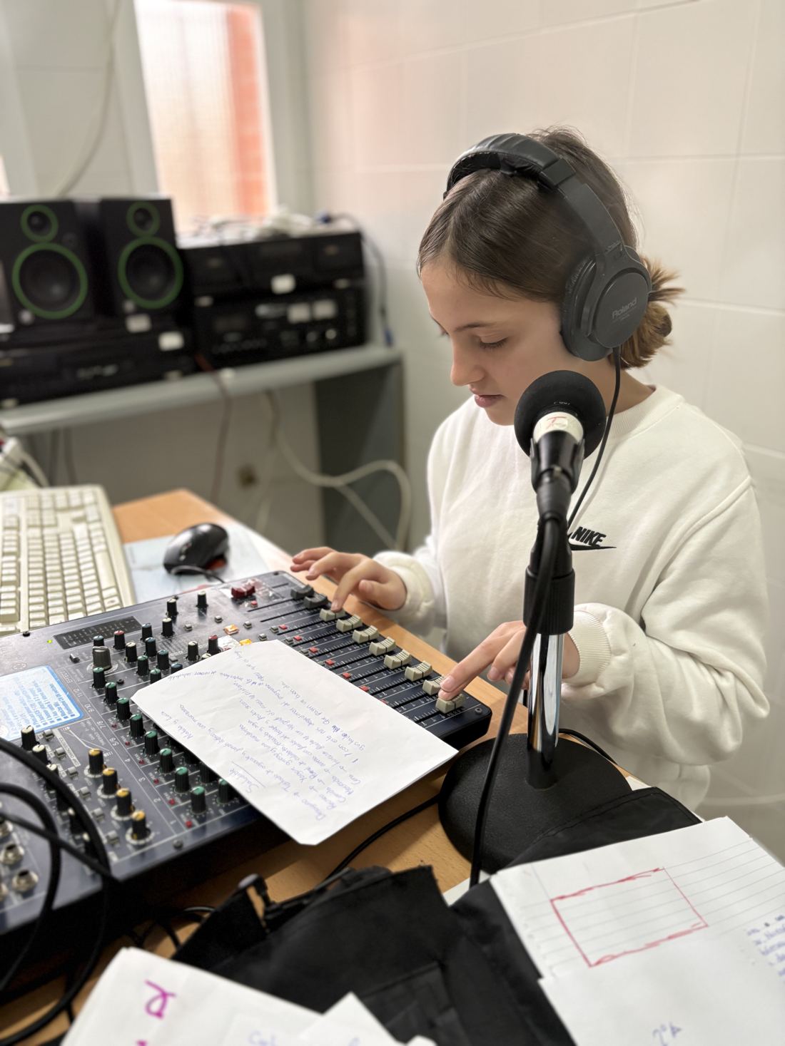 A student at the mixing desk of the school radio station