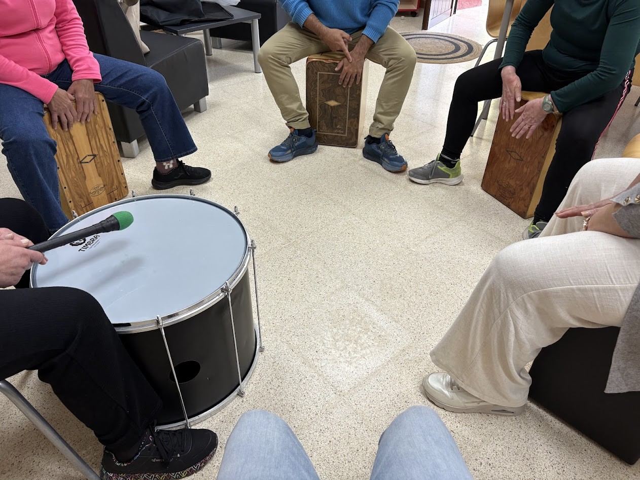 A circle of people playing cajones